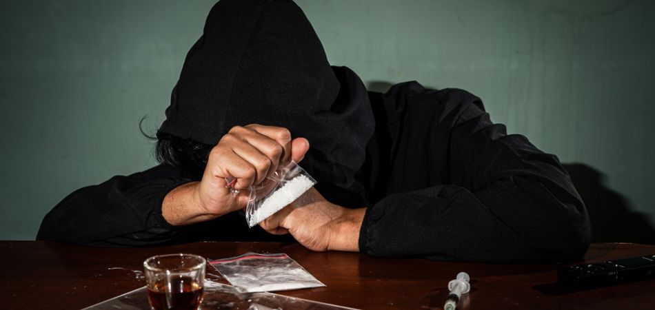 Person struggling with their drug addiction