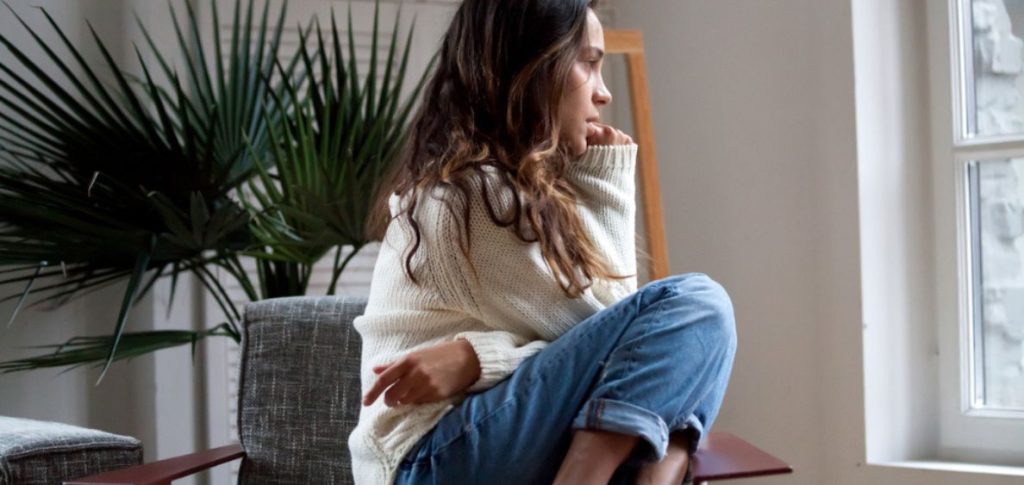 depressed young girl sitting on chair