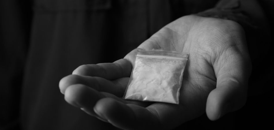 cocaine addiction pouch in man hand